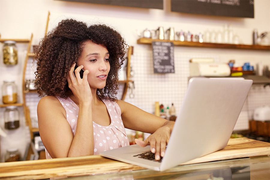 female-small-business-owner-on-phone-and-laptop-columbus-oh